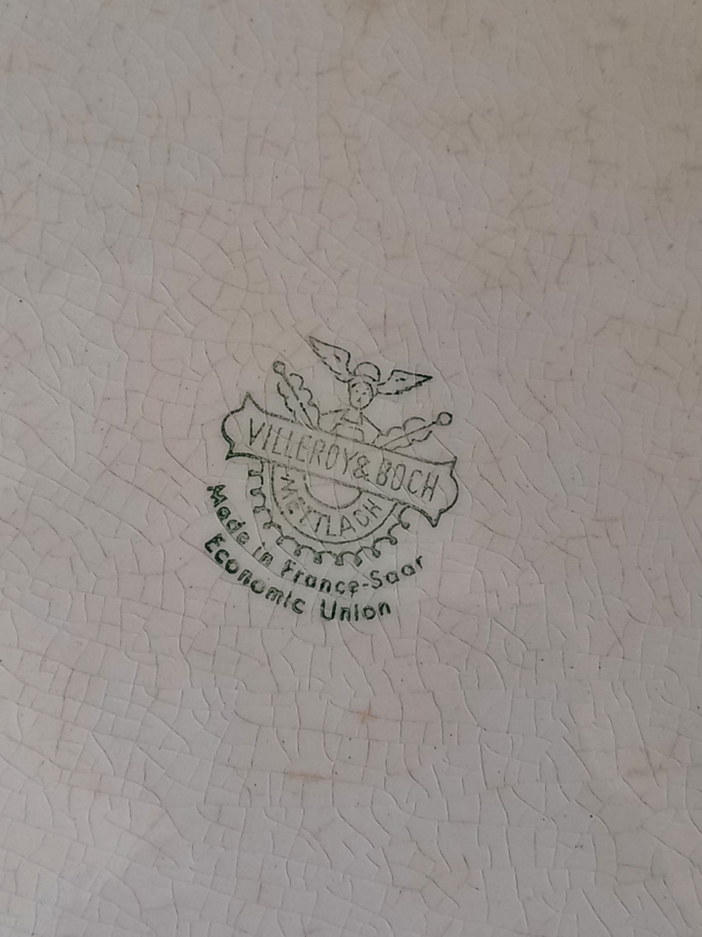 A beautiful vintage oval ironstone serving plate with decorative edges in a time-worn creamy white with super tea-staining that gives it that shabby chic finish many of us desire.