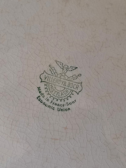 A beautiful vintage oval ironstone serving plate with decorative edges in a time-worn creamy white with super tea-staining that gives it that shabby chic finish many of us desire.