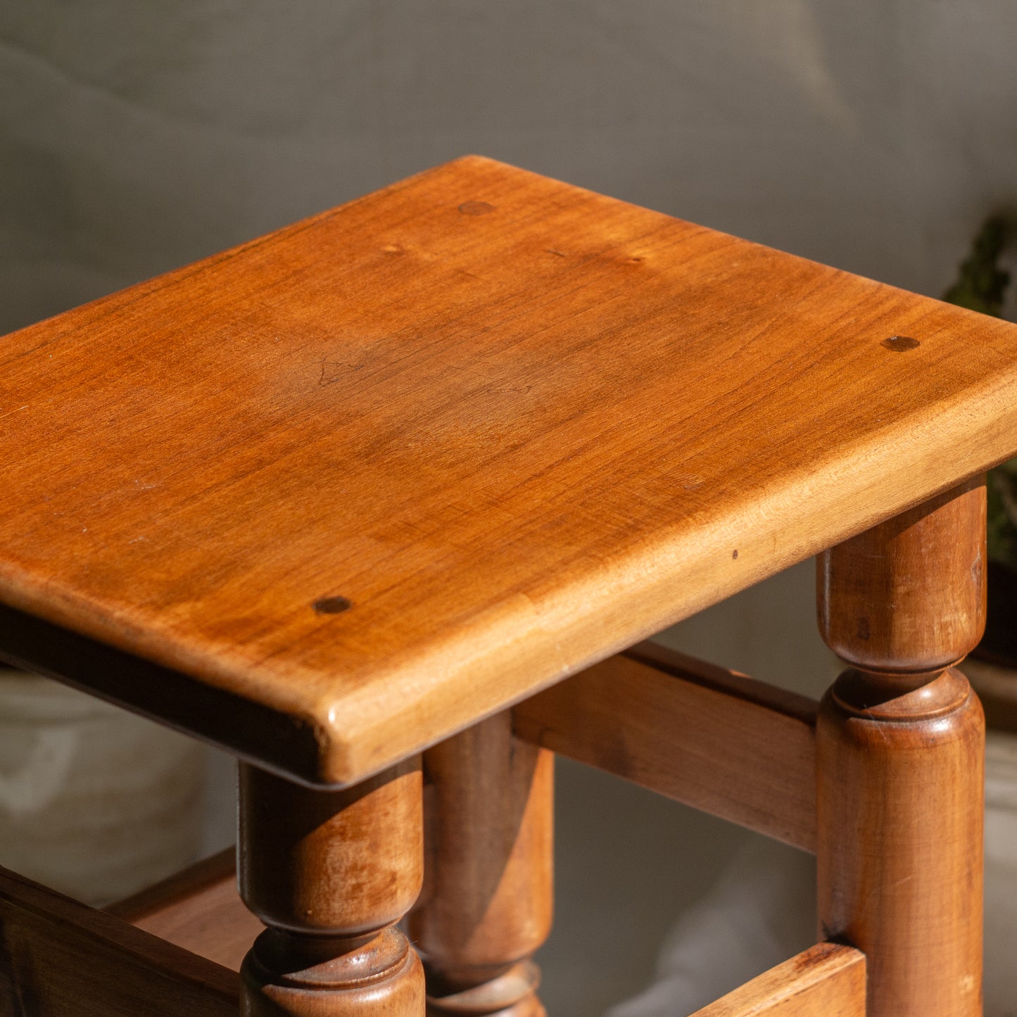 A handsome vintage French wooden stool in a lovely shade of honey-coloured brown. This old stool is very solid and would make a great plant stand (we currently use one on our desk as a plant stand and it looks great!) and many other decorative possibilities.