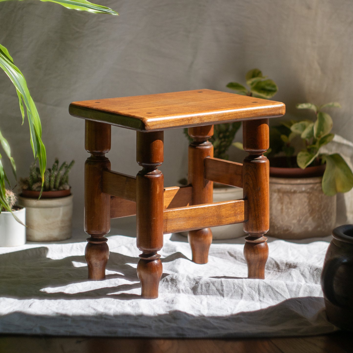 A handsome vintage French wooden stool in a lovely shade of honey-coloured brown. This old stool is very solid and would make a great plant stand (we currently use one on our desk as a plant stand and it looks great!) and many other decorative possibilities.