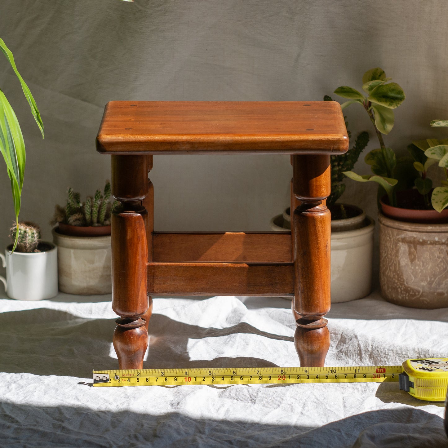 A handsome vintage French wooden stool in a lovely shade of honey-coloured brown. This old stool is very solid and would make a great plant stand (we currently use one on our desk as a plant stand and it looks great!) and many other decorative possibilities.
