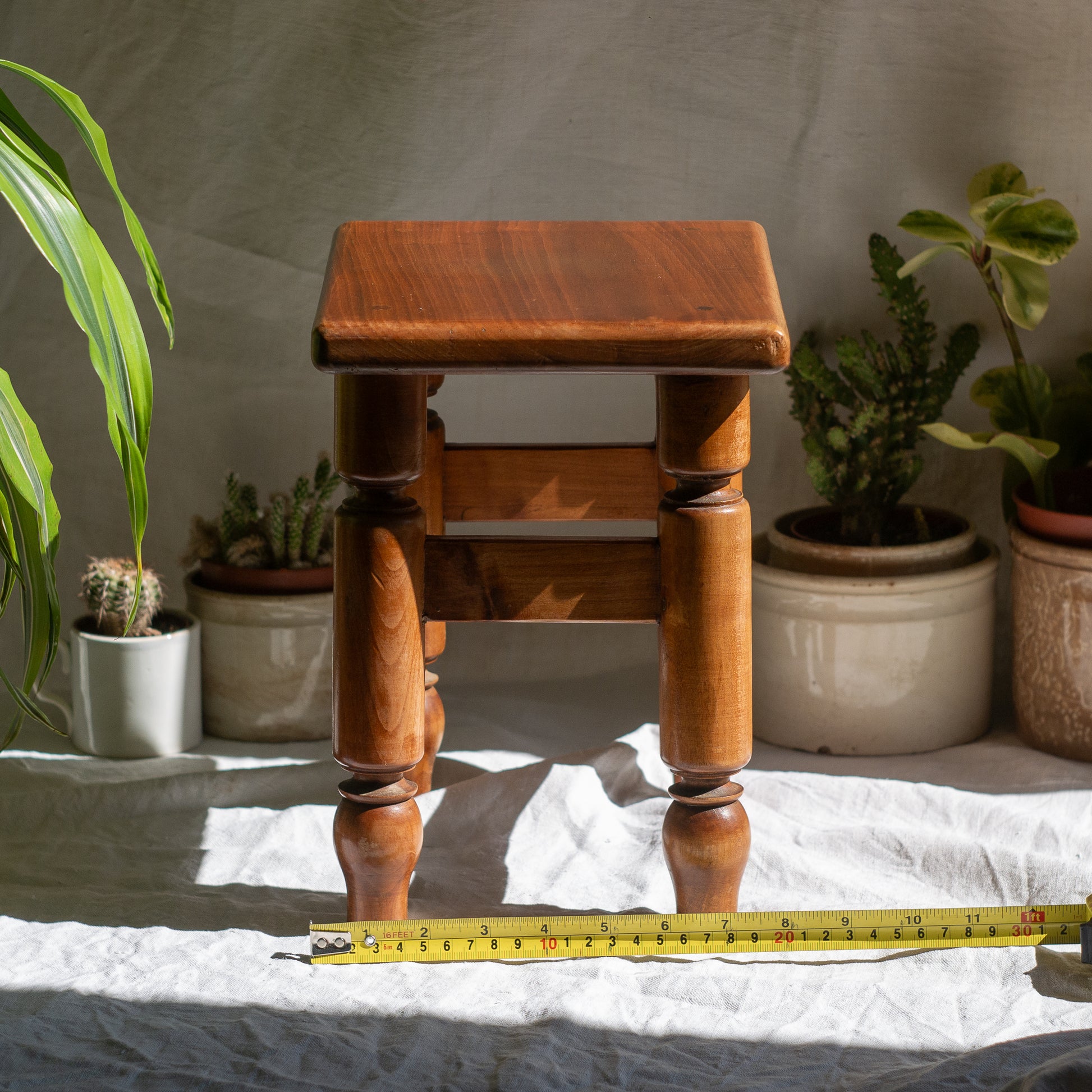 A handsome vintage French wooden stool in a lovely shade of honey-coloured brown. This old stool is very solid and would make a great plant stand (we currently use one on our desk as a plant stand and it looks great!) and many other decorative possibilities.