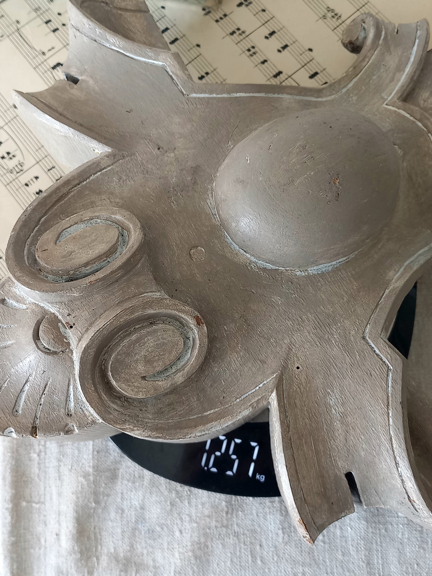 A French antique decorative carved wooden pediment that has been tastefully painted and worn to give an attractive shabby chic finish.