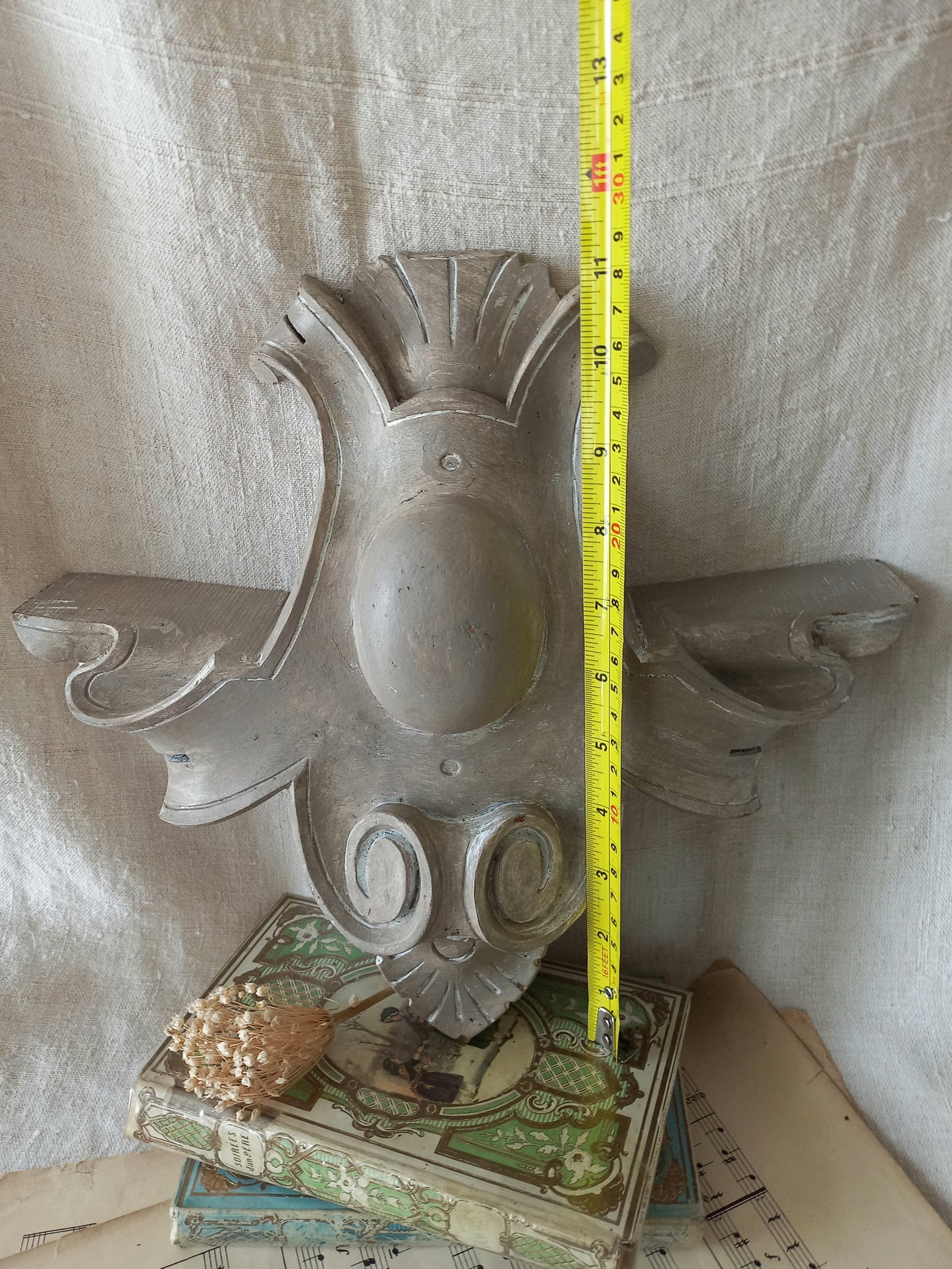 A French antique decorative carved wooden pediment that has been tastefully painted and worn to give an attractive shabby chic finish.